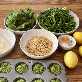 Photo of ingredients for garlic scape pesto and sample pesto in mini muffin tin.